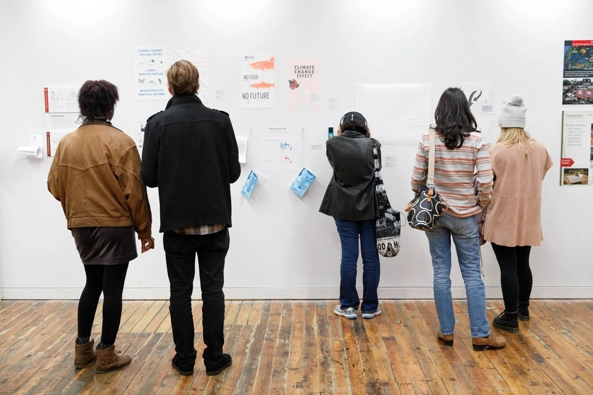 Community members look at showcase art